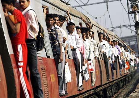 Commuters travel in a suburban train in Mumbai.