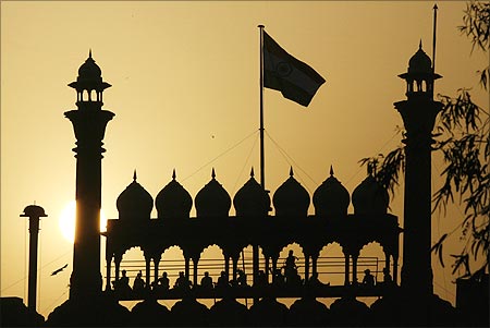 Indian soldiers are silhouetted against the rising sun at the Red Fort.