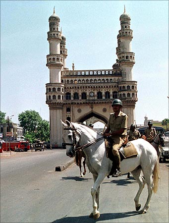 An anti-riot policeman rides on horseback near Char Minar, Hyderabad.