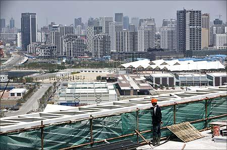 Workers clean the exterior of the National Grand Theatre, nicknamed the 'egg', in Beijing.