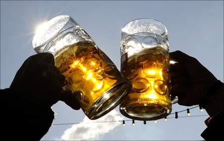 Happy tourists toast each during Oktoberfest in Munich.