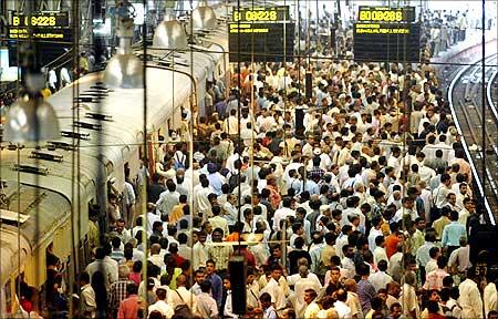 Commuters at a crowded railway station in Mumbai.