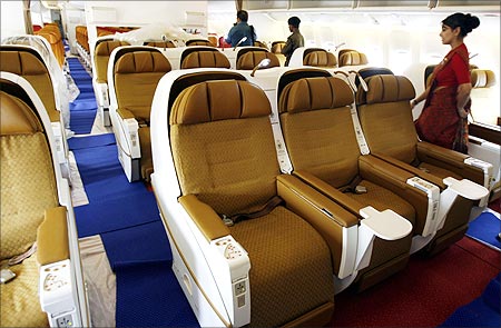 People walk inside the business class section of Air India's new Boeing 777-200 LR aircraft.
