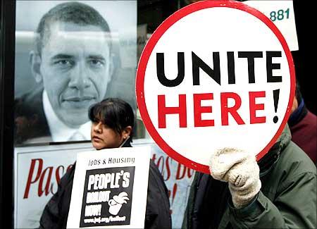 Protesters walk the sidewalk outside the Bank of America building in support of the 200 laid-off workers of Republic Windows and Doors in Chicago.