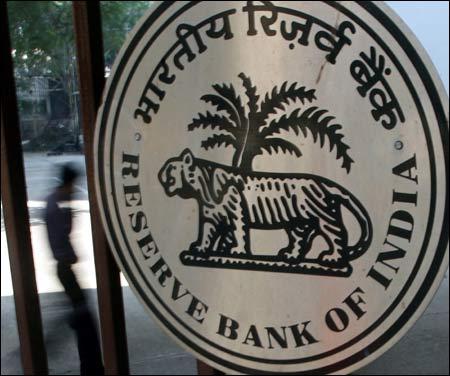 A man walks past the entrance of the Reserve Bank of India in Mumbai.