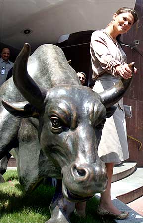 Sweden's Crown Princess Victoria poses with a bronze replica of the bull during her visit to the Bombay Stock Exchange.
