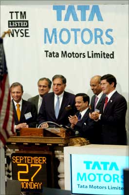 Rahan Tata (C), chairman of Tata Motors Limited, rings the opening bell to celebrate the company's listing on the New York Stock Exchange on, September 27, 2004. | Photograph: Henny Ray Abrams/Reuters