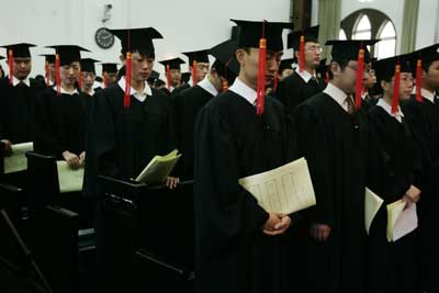 Chinese students pray during their graduation ceremony. | Photograph: Aly Song/Reuters
