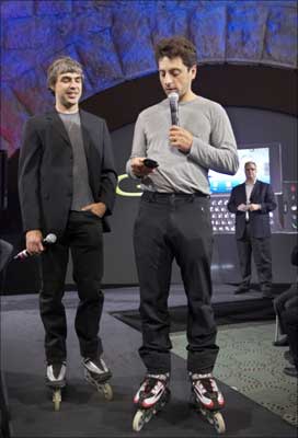 Larry Page (left) and Sergey Brin, founders of Google, show the new G1 phone running Google's Android software in New York. | Photograph: Jacob Silberberg/Reuters