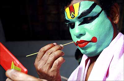 An artist gets ready to perform during the festivities marking the start of the annual harvest festival, Onam, in Kerala