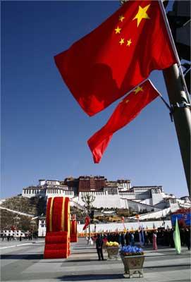 Chinese national flags fly in front of the Potala Palace in Lhasa, Tibet.