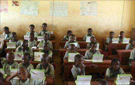 Nigerian pupils work on computers at the LEA primary school in Abuja.