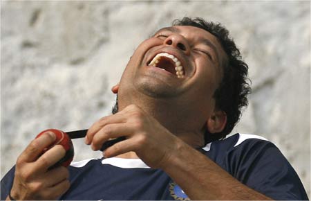 Sachin Tendulkar laughs during a cricket training session.