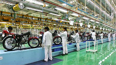 Employees work in an assembly line at Hero Honda's newly inaugurated plant in Haridwar