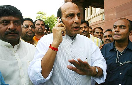 Bharatiya Janata Party President Rajnath Singh speaks on his mobile phone outside Parliament.