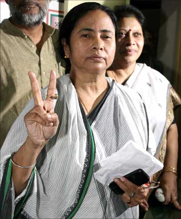 Mamata Banerjee, chief of Trinamool Congress, shows a victory sign during a new conference after she won her parliamentary seat.