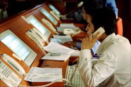 Brokers engage in trading at a brokerage firm in Mumbai.