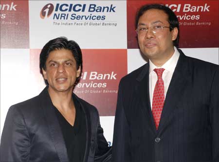Sonjoy Chatterjee (R), managing director and chief executive officer of ICICI Bank UK, and Bollywood star Shahrukh Khan