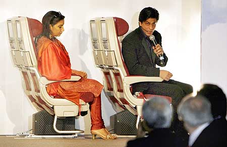 Actors Shah Rukh Khan (R) and Shabana Azmi attend a function to showcase Jet's new logo and uniform