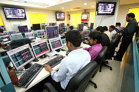 Stock brokers trade at a brokerage firm in Kolkata.