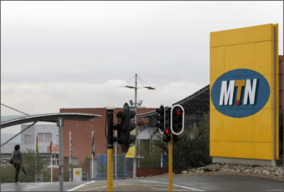 A woman walks past the headquarters of South Africa's MTN Group in Johannesburg.