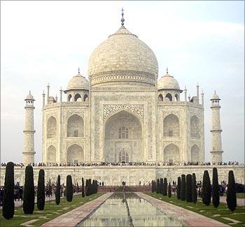 Tourists stand in front of the historic Taj Mahal in Agra.