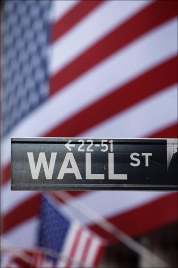 The Wall Street sign is seen in front of the New York Stock Exchange.