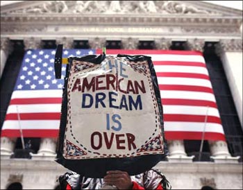 A demonstrator holds a sign reading 'The American dream is over' during a rally outside Wall Street in New York.