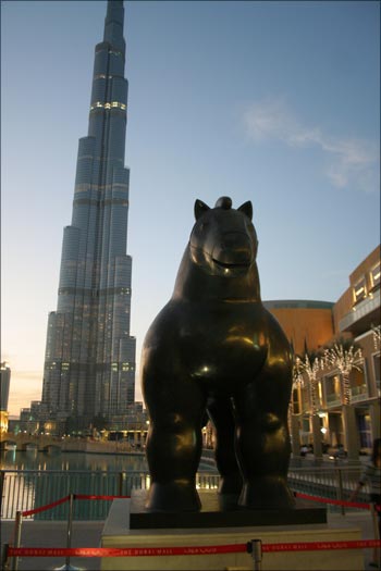 Figurative artist Fernando Botero's 'Horse 2007' against the backdrop of the Burj Dubai. The work of art celebrates the equestrian heritage of the Arab world in Downtown Burj.