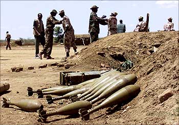 Sudan People's Liberation Movement (SPLM) rebel stands next to a pile of ammunition at Kapoeta.
