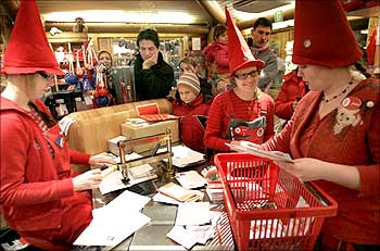 People dressed as elves post mark letters with the stamp from Santa Claus' Post Office near Rovaniem