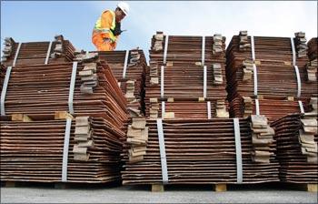 A security guard, in Valparaiso near Santiago, inspects a copper shipment to be delivered to China.