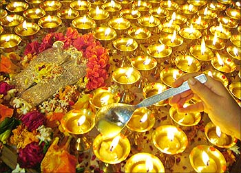 A Hindu devotee lights lamps during Diwali festival in Amritsar.
