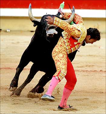 Spanish matador Antonio Ferrera tries to evade a fighting bull during a bullfight at the Plaza de Toros at the San Fermin festival in Pamplona.
