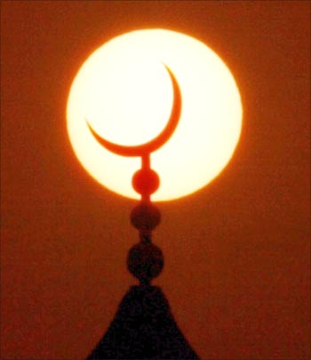 The sun sets behind a mosque during Ramadan in Dubai.