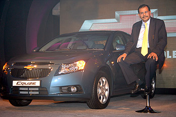P Balendran, vice president, GM India, poses with the car.