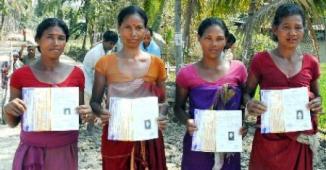 Rural women showing NREGA cards