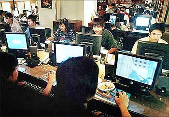 Teenagers play computer games in a Hong Kong Internet cafe.