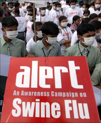 Schoolchildren hold a banner as they take part in a swine flu awareness run in Hyderabad.