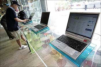 People use computers to surf the internet at the free internet zone for visitors in Seoul.