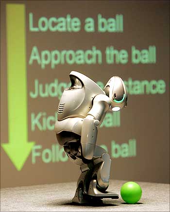 A robot kicks a ball.