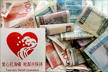 Banknotes are seen inside a donation box for tsunami victims in Hong Kong.