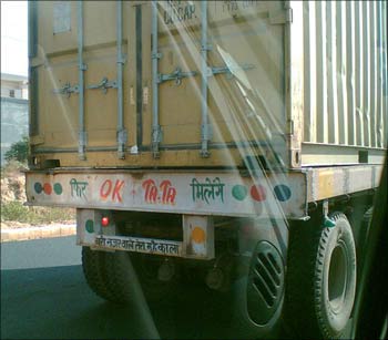 A truck with the ubiquitous message emblazoned on the rear: 'OK Tata '