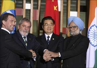 Image: Russia's President Dimitry Medvedev (L-R), Brazil's President Luiz Inacio Lula da Silva, China's President Hu Jintao and Prime Minister Manmohan Singh join hands during a photocall at Itamaraty Palace in Brasilia. Photograph: Roberto Jayme/Reuters