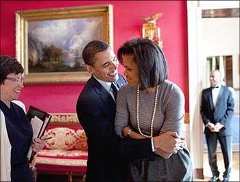 Image: Obama hugs his wife, Michelle, in the White House Red Room as Senior Advisor Valerie Jarrett smiles. Photographs Pete Souza/The White House/Handout/ Reuters