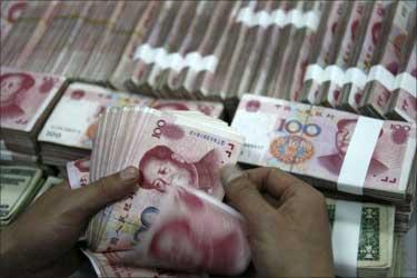 An employee counts yuan banknotes at a branch of the Industrial and Commercial Bank of China in Huaibei, Anhui province.