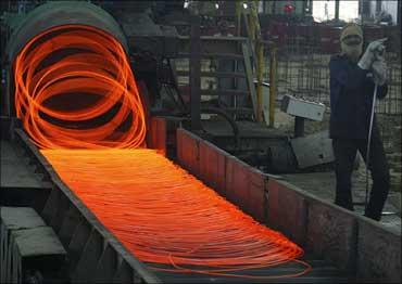 A labourer works inside a steel factory in Kanpur.