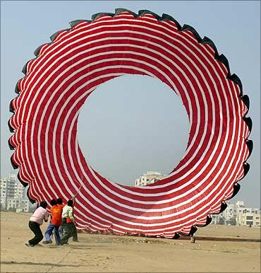 People trying to fly a kite in Ahmedabad during the kite flying festival.