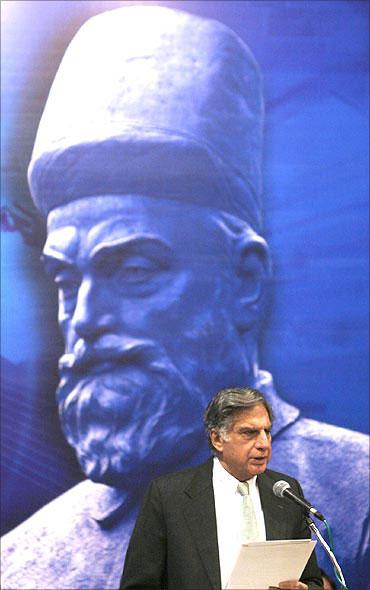 Ratan Tata speaks in front of a portrait of Tata Group founder Jamsetji Nusserwanji Tata.