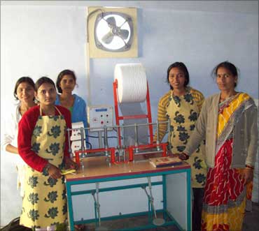 Rural women pose with the machine.
